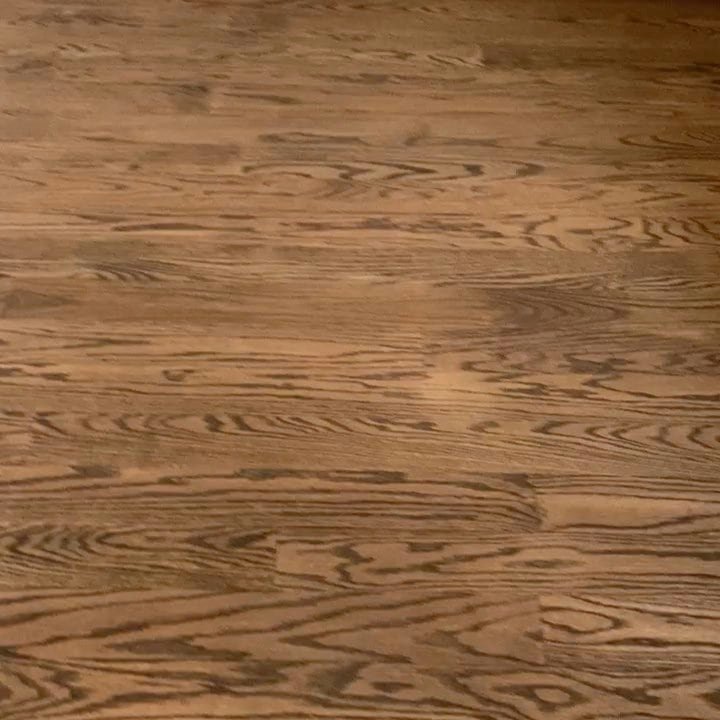 Freshly stained hardwood floor boards in a NYC home ready for the first protective finish coat.