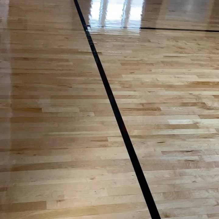 Custom center logo and athletic striping on a newly installed hardwood floor at a Brooklyn school in NYC.