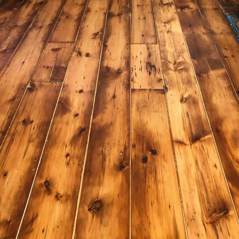 Polished antique hardwood floors restored to a rich mahogany glow inside a classic NYC apartment.
