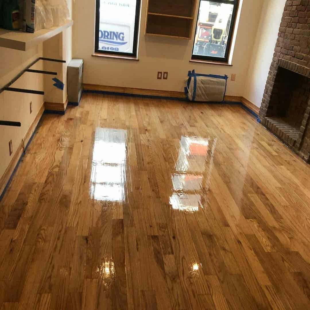 Close up of a smooth satin finish applied to refurbished teak floors inside a New York City residence.