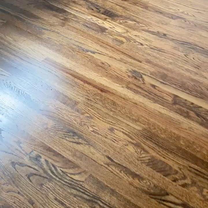 Close up of the smooth grain and glossy finish on a newly refinished NYC hardwood floor.